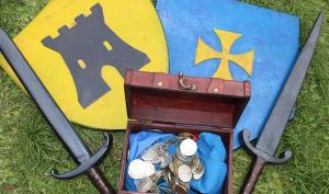 Deux boucliers, deux épées et un coffre rempli de pièce d'or